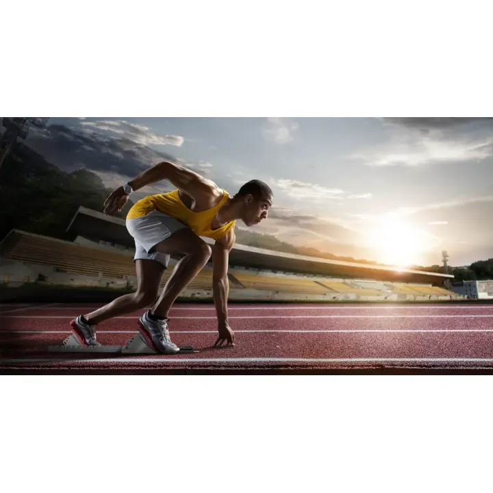 Fototapeta Sportowiec W Bloku Startowym – Dynamika Biegu na Stadionie – produkt
