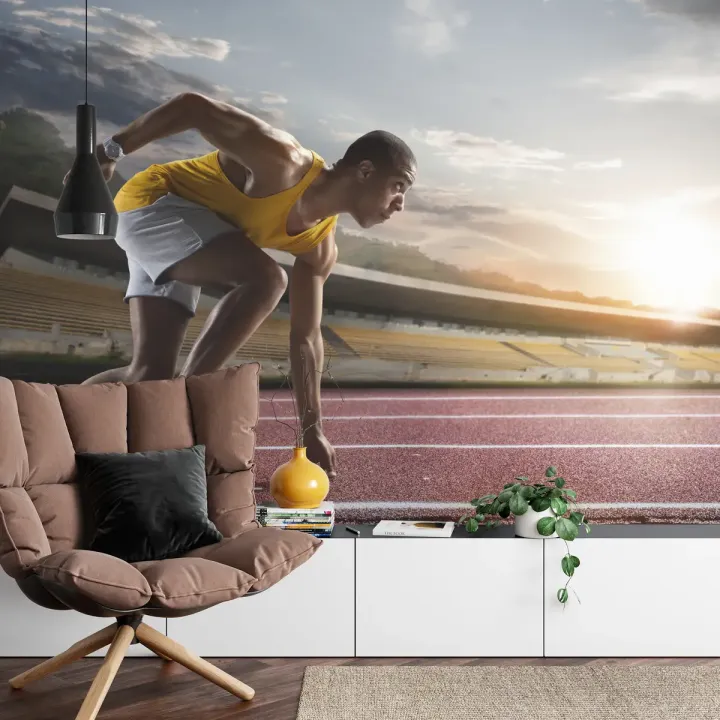 Fototapeta Sportowiec W Bloku Startowym – Dynamika Biegu na Stadionie